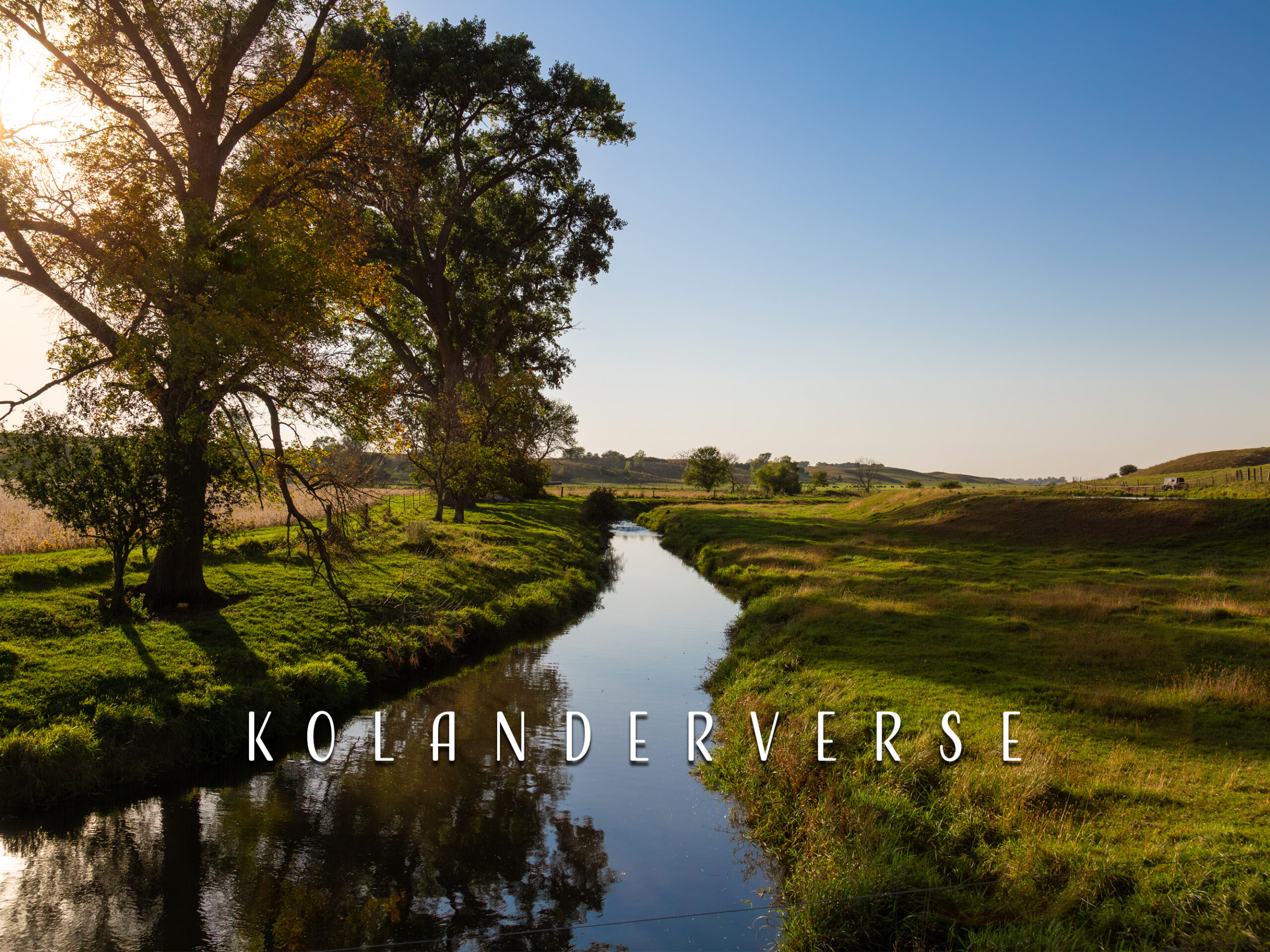 Minnesota Wall Art Photograph of a green pasture during the golden hour with the blue sky reflected in the water.