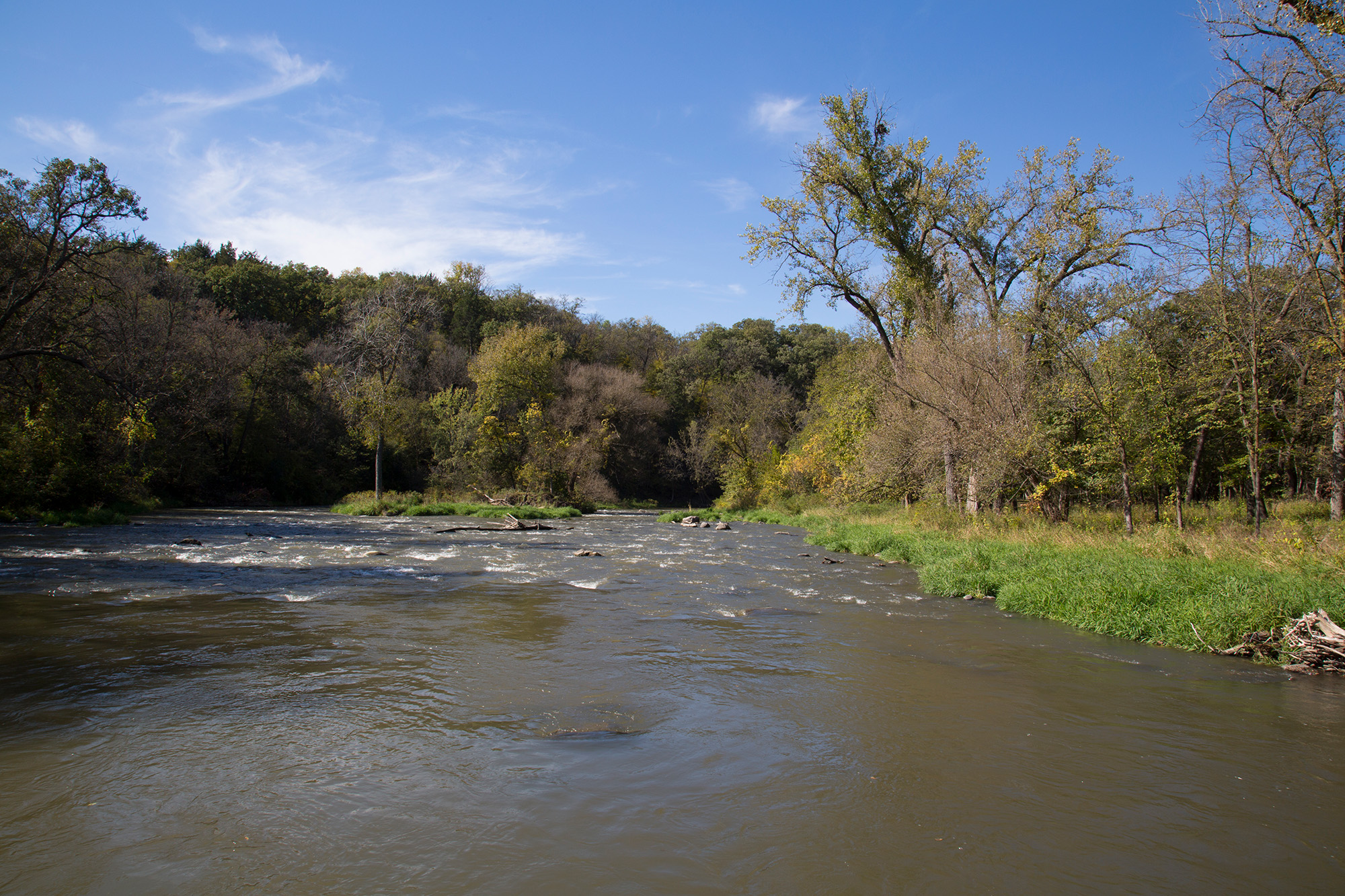 Ramsey Park Redwood Falls 3 Redwood Falls River flowing with a blue sky, and trees lining the banks.